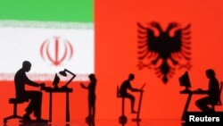 Figurines with computers are seen in front of Iranian and Albanian flags in this photo illustration created Sept. 10, 2022. 