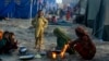 Survivors of heavy flooding from monsoon rains take refuge as they prepare tea at a makeshift tent camp set up by the U.N. Refugee Agency UNHCR, in Sukkur, Pakistan, Sept. 10, 2022. 