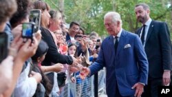 King Charles III greets members of the public outside Clarence House in London after he was formally proclaimed monarch by the Privy Council, Sept. 10, 2022. 