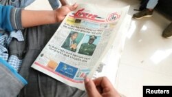 A man reads a newspaper with the pictures of Amhara state President Ambachew Mekonnen, killed in Bahir Dar, and of Army Chief of Staff Seare Mekonnen, who was shot by his bodyguard, on a street in Addis Ababa, Ethiopia, June 24, 2019.