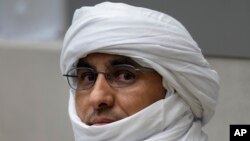Al Hassan Ag Abdoul Aziz Ag Mohamed Ag Mahmoud waits for judges to enter the courtroom of the International Criminal Court in The Hague, Netherlands, June 26, 2024.
