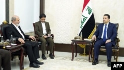 A handout picture released by Iraq's Prime Minister's Media Office on Feb. 5, 2024, shows Iraq's Prime Minister Mohamed Shia al-Sudani, right, meeting with Ali Akbar Ahmadian, left, secretary of Iran's Supreme National Security Council, in Baghdad. 