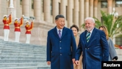 Brazil’s President Luiz Inacio Lula da Silva, left, and China’s President Xi Jinping attend a welcoming ceremony at the Great Hall of the People in Beijing, April 14, 2023. (Ricardo Stuckert/Handout via Reuters)