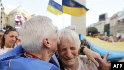 Pro-Ukraine demonstrators take part in a rally commemorating the second anniversary of the Russian invasion of Ukraine at the Obelisk in Buenos Aires, Argentina, Feb. 24, 2024.