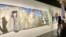 Many paintings at the Palestine exhibit depict barriers and barbed wire. The exhibit "What Palestine Brings to the World" at the Arab World Institute in Paris, runs through Nov. 19, 2023. (Lisa Bryant/VOA)