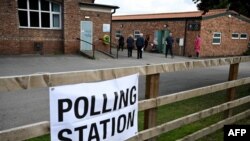 Voters arrive to a polling station at the Scout & Guide headquarters in Sowerby, north of England, July 4, 2024 as Britain holds a general election. Polls are predicting that Labour will win its first general election since 2005.