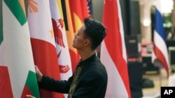An Indonesian worker prepares the flags of the member countries of the Association of Southeast Asian Nations in Jakarta, Indonesia, July 10, 2023.
