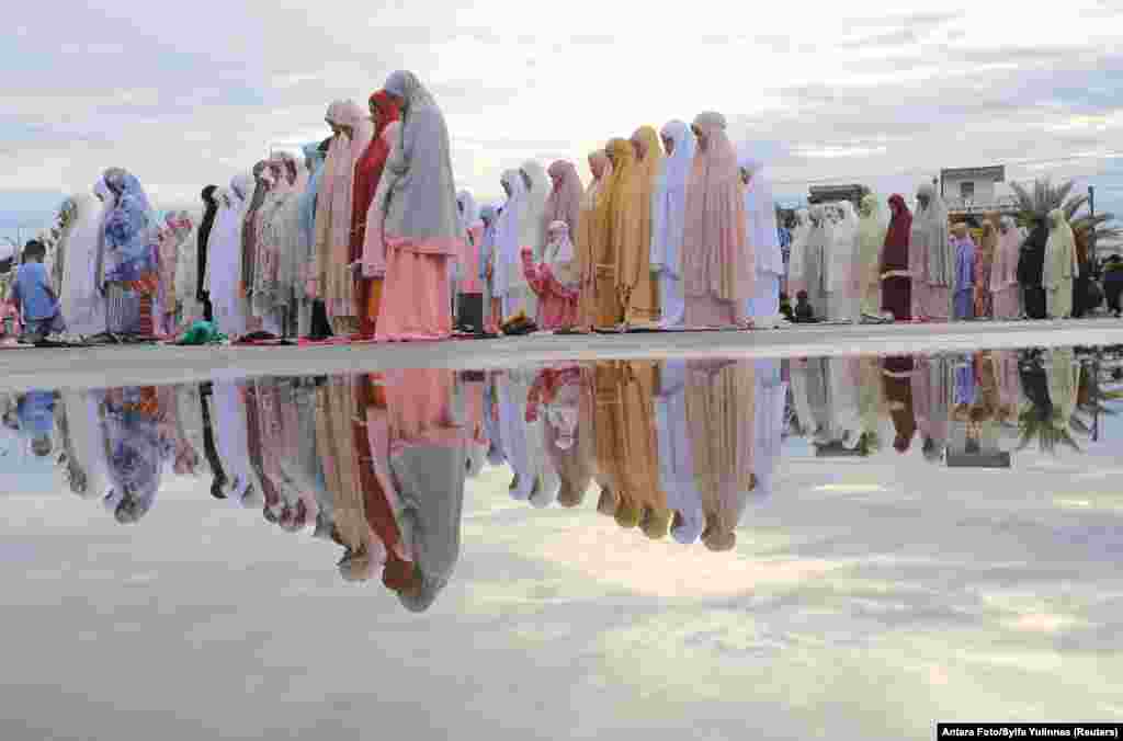 Indonesian Muslims offer mass prayers at Baitul Makmur Grand Masque during Eid al-Adha celebrations in Meulaboh, West Aceh regency.