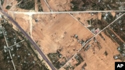 This satellite image provided by Maxar Technologies shows earth grading activity during buffer zone construction in Rafah, Egypt, Feb. 10, 2024. (Maxar Technologies via AP)