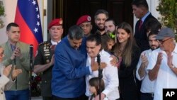 Venezuelan President Maduro, center left, embraces Alex Saab after Saab arrived at Miraflores presidential palace in Caracas, Venezuela, Dec. 20, 2023.