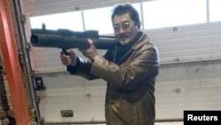 FILE - Takeshi Ebisawa is pictured with a rocket launcher during a meeting with an informant and two undercover Danish police officers at a warehouse in Copenhagen, Feb. 3, 2021, in a photo from a Drug Enforcement Administration criminal complaint.