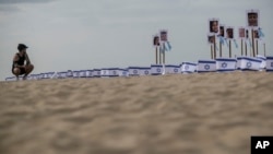Images of Israeli children who have died during the war between Israel and Hamas are displayed on Copacabana beach, in Rio de Janeiro, Brazil, Nov. 7, 2023.