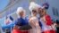 A trio of New Orleans women dressed as Marie-Antoinette enjoy this year's Fête Française, a New Orleans street festival celebrating French culture, on March 25, 2023. 
