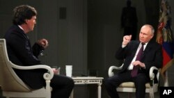 FILE - In this photo released by Sputnik news agency, Feb. 9, 2024, U.S. commentator Tucker Carlson interviews Russian President Vladimir Putin in Moscow on Feb. 6, 2024. Part of the interview was used to create a history quiz that Russian school children took this month.