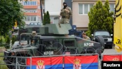 U.S. members of the NATO-led Kosovo Force (KFOR) stand guard outside municipal offices in Leposavic, Kosovo, June 2, 2023. 