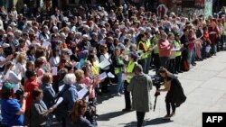 Several choirs sing together in support of peace in Ukraine, in the center of Madrid, Spain, March 26, 2023.