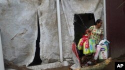 A woman carries diapers out of a supermarket after Hurricane Otis ripped through Acapulco, Mexico, Oct. 25, 2023. 