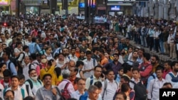 FILE - People wait for their train on platforms at the Chhatrapati Shivaji Terminus (CST) railway station Mumbai, India, April 19, 2023. (Photo by Punit PARANJPE / AFP)