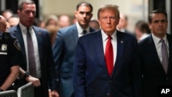 FILE — Former U.S. President Donald Trump arrives at a criminal court in New York, Feb. 15, 2024. On Wednesday, an Illinois judge barred Trump from Illinois' Republican presidential primary ballot because of his role in the Jan. 6, 2021, insurrection at the U.S. Capitol.