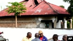 Image from video of people in front of the Lhubiriha Secondary School following an attack on the school near the border with Congo, in Mpondwe, Uganda, June 17, 2023.