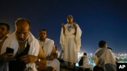 Muslim pilgrims gather at top of the rocky hill known as the Mountain of Mercy, on the Plain of Arafat, during the annual Hajj pilgrimage, near the holy city of Mecca, Saudi Arabia, June 15, 2024.