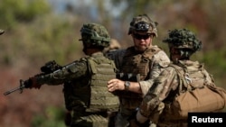 Seorang tentara AS memeriksa perlengkapan senjata tentara Filipina dalan latihan gabungan yang disebut "Salaknib" di Fort Magsaysay, Nueva Ecija, Filipina, pada 31 Maret 2023. (Foto: Reuters/Eloisa Lopez)