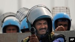 Rapid Action Force personnel guard a major highway at Singhu near New Delhi to stop thousands of protesting farmers from entering the capital, India, Feb.13, 2024.