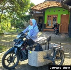 Kuni Fatonah-penyandang difabel daksa, mampu naik sepeda motor yang direncang khusus agar bisa membawa kursi rodanya (dok. pribadi).