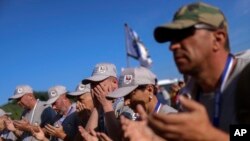 Bosnian Muslim men pray before the start of a march to remember the 1995 Srebrenica massacre, in Nezuk, Bosnia, July 8, 2023.
