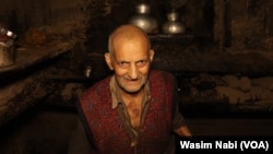 FILE - Ghulam Ahmed Wani runs one of last ox-driven oil mills in the town of Pampore, district Pulwama of Jammu and Kashmir, June 2023.