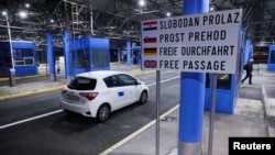 FILE - A vehicle passes through a visa-free border crossing in the EU's Schengen zone, in Bregana, Croatia, Jan. 1, 2023. Kosovo is joining the zone on Jan. 1, 2024. 