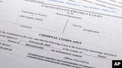 The criminal complaint against Jack Teixeira is photographed April 14, 2023. The Massachusetts Air National Guard member appeared in court on Friday in Boston, accused in the leak of highly classified military documents.