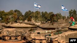 Israeli battle tanks are deployed at a position along the border with the Gaza Strip and southern Israel on Dec. 31, 2023.