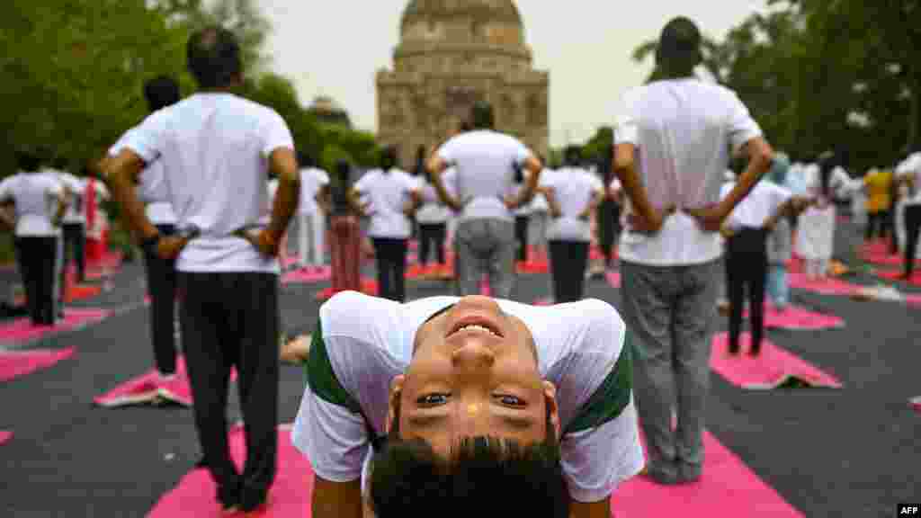 People take part in a yoga session at Lodhi gardens on International Day of Yoga, in New Delhi.