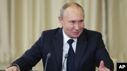 Russian President Vladimir Putin speaks during talks with the vice chairman of China's Central Military Commission, at the Novo-Ogaryovo residence outside Moscow, Russia, Nov. 8, 2023. 