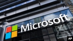 FILE - A Microsoft sign hangs on a building in New York, May 6, 2021. The U.S. Federal Trade Commission has opened a broad antitrust investigation into Microsoft, a source said this week.
