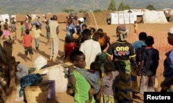 FILE - Refugees wait for registration at Kapise camp in Malawi's Mwanza district, Jan. 18, 2016.