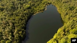 Trees surround Crawford Lake in Milton, Ontario., on Monday, July 10, 2023. (Cole Burston/The Canadian Press via AP)