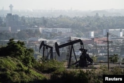 FILE - Active pumpjacks from oil wells are pictured at the Inglewood Oil Field, the largest urban oil field in the United States, from the Baldwin Hills Scenic Overlook in Culver City, California, March 10, 2022.