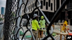 File - Construction workers work with rebar at a site on Tuesday June 6, 2023, in New York. 