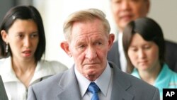 FILE - Former U.S. Army deserter to North Korea, Charles Jenkins, is seen with his daughters Mika, rear left, and Brinda at Narita International Airport, Japan, June 14, 2005.