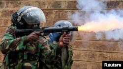 FILE - A riot police officer fires tear gas at protesters opposing the imposition of tax hikes by the government in Nairobi, Kenya, July 19, 2023.
