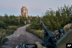 FILE - A Ukrainian soldier sits in his position in Avdiivka, Donetsk region, Ukraine, Aug. 18, 2023. Ukrainian forces claimed on Feb. 8, 2024, to have shot down a Russian attack helicopter near Avdiivka, where the sides are fighting from street to street.
