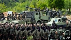 FILE - Fighters from the Lebanese militant group Hezbollah carry out a training exercise in Aaramta village in the Jezzine District, southern Lebanon, May 21, 2023. 