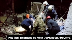 Emergency responders retrieve bodies from the rubble of a damaged building following a Ukrainian attack in a location given as Lysychansk in the occupied eastern Ukrainian region of Luhansk, in this screen grab obtained from a video released, Feb. 3, 2024.