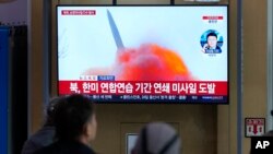FILE - A TV screen shows a file photo of a North Korean missile launch during a news program, at the Seoul Railway Station in Seoul, South Korea, March 22, 2023. 