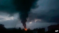 This grab taken from video distributed by Siranush Sargsyan's Twitter account on Monday, Sept. 25, 2023, shows smoke rising after a fuel depot explosion near Stepanakert, Nagorno-Karabakh.