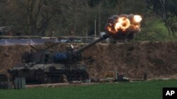 An Israeli mobile artillery unit fires a shell from southern Israel towards the Gaza Strip, in a position near the Israel-Gaza border, Feb. 22, 2024. 