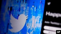 FILE - The Twitter splash page is seen on a digital device, April 25, 2022, in San Diego. Twitter on April 20, 2023, began making good on its promise to remove the blue checks from accounts that don't pay monthly fees to keep them. 