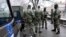 FILE - NATO peacekeeping EUFOR troops stop as they patrol in downtown Sarajevo, Bosnia, March 7, 2022. 